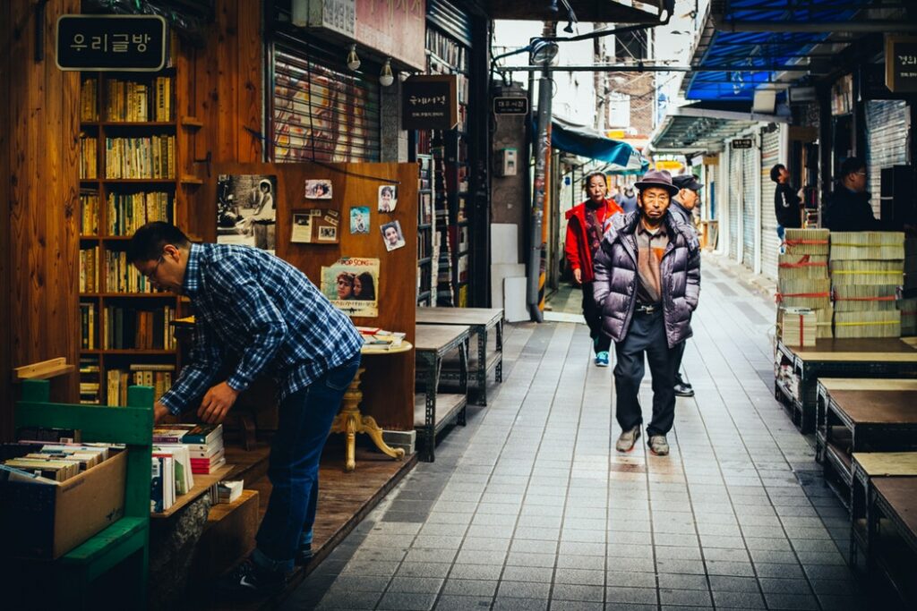 Man looking through crates of books